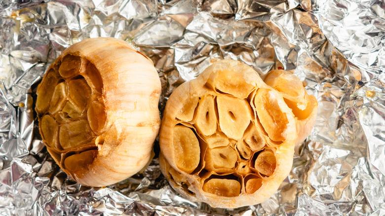 roated garlic bulbs on tin foil