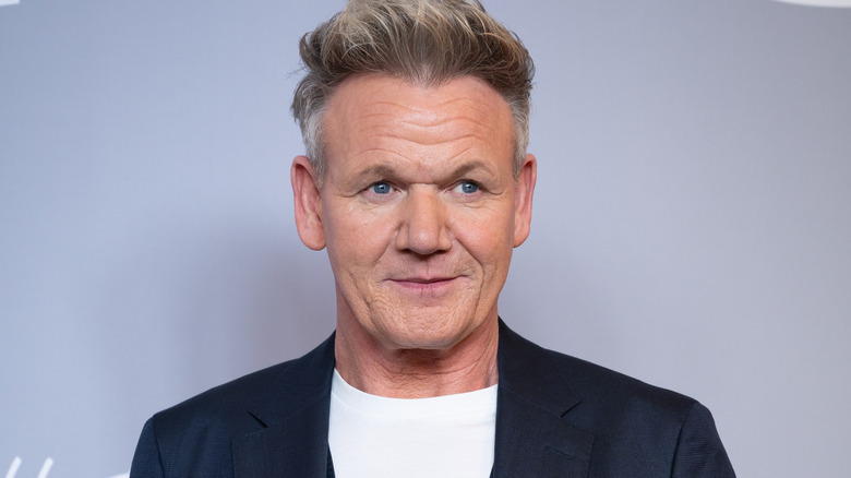 Gordon Ramsay smiling in white shirt and black blazer