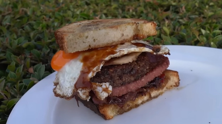 Gordon Ramsay's Scottish breakfast sandwich, containing haggis, Lorne sausage, fried egg, caramelized onions and brown sauce