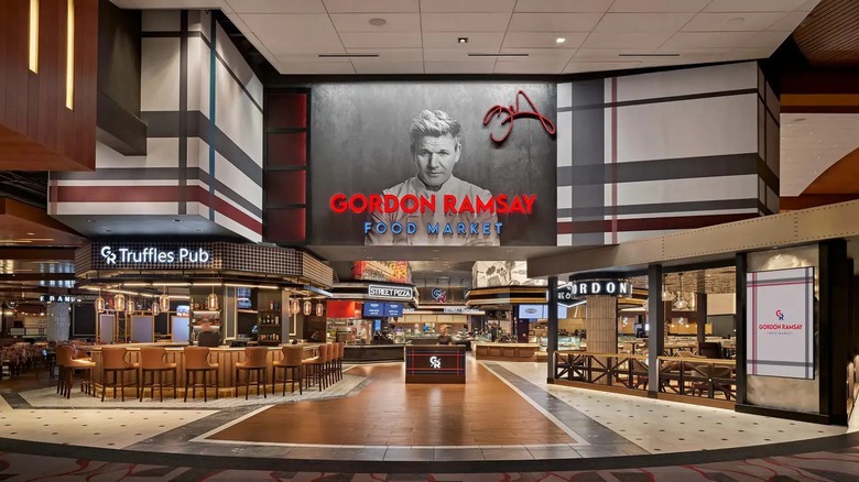 An image of Gordon Ramsay above the entrance to Gordon Ramsay food market