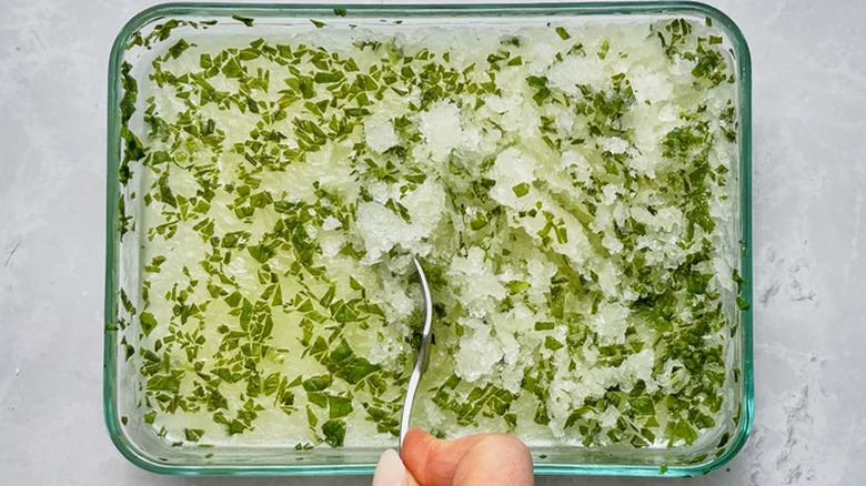 A dish with basil granita and a spoon