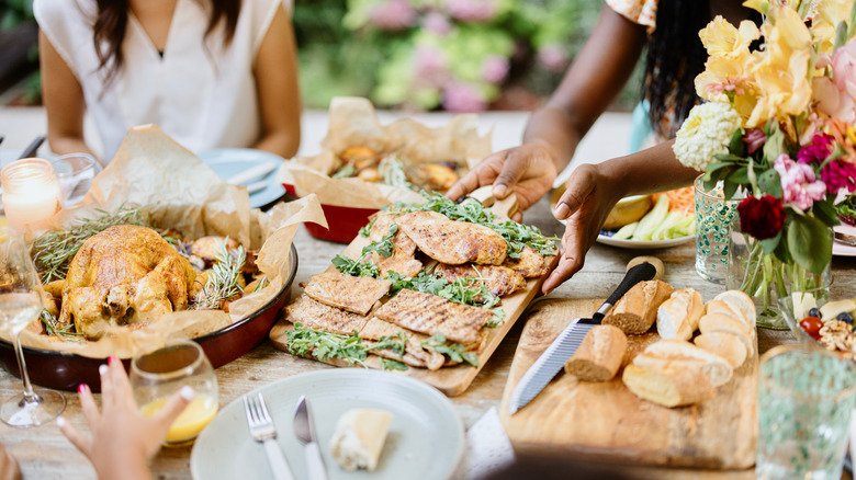 family eating dinner with chicken meat and bread slices