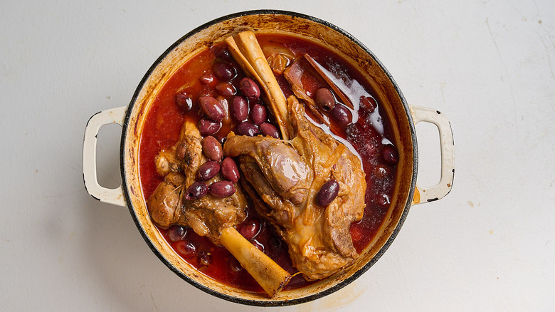 olives in a pot with lamb shanks