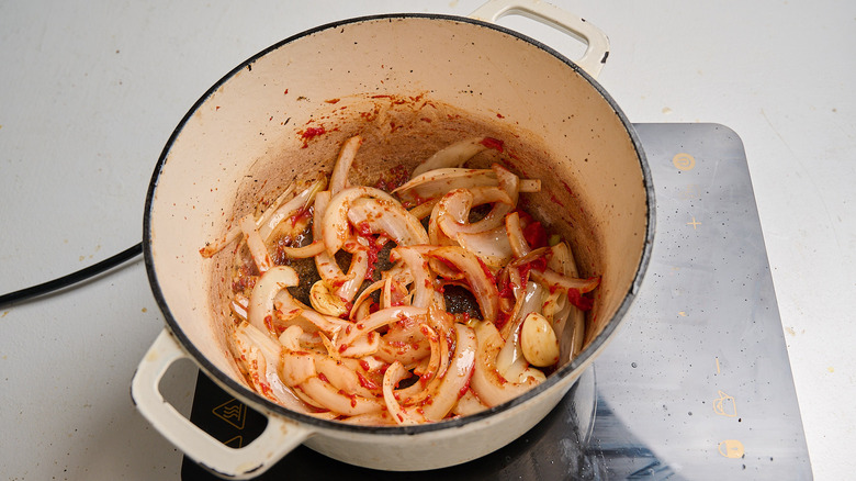 tomato paste added to onion and garlic