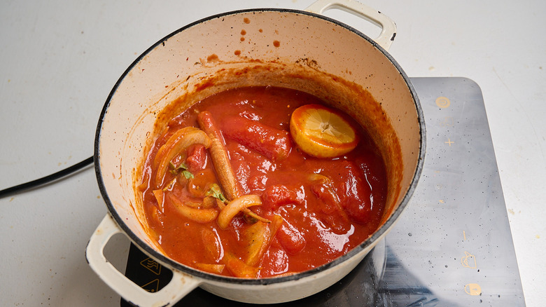 tomatoes and seasonings added to pot