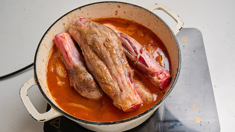 lamb shanks submerged in broth