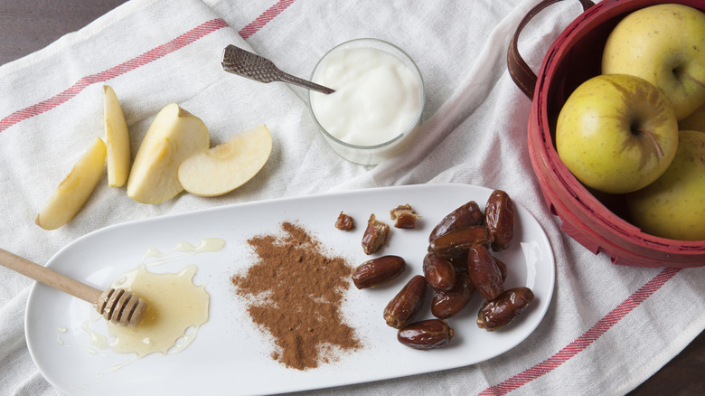 Fresh apples, yogurt, honey, cinnamon, and dates