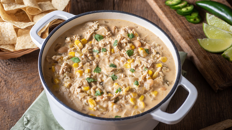 Overhead view of pot of creamy white bean chili on a table.