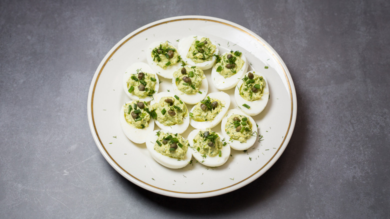 green deviled eggs on plate
