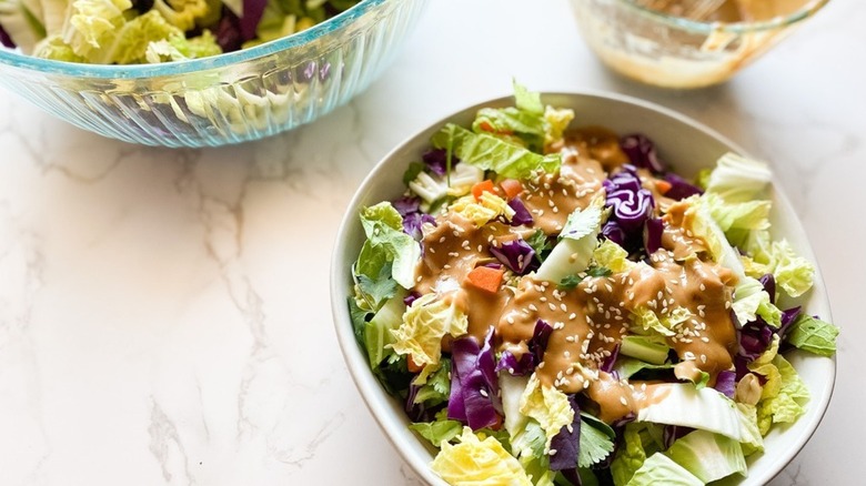 Bowl of cabbage salad with creamy peanut dressing