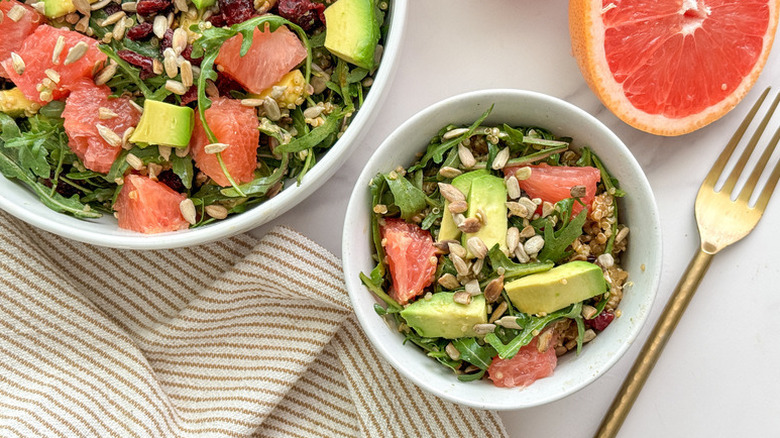 Grapefruit and avocado quinoa salad served in two white bowls