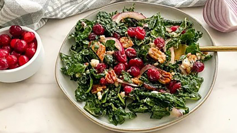 Kale, cranberry, and walnut salad on plate