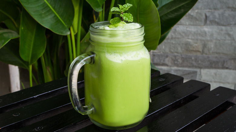 Green smoothie with leaves on top