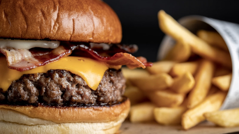 Thick cheeseburger with bacon and fries