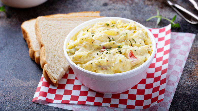 bowl of potato salad with slices of bread