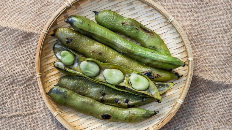 grilled fava bean pods in a basket