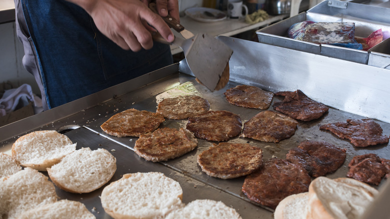 Making burgers on a flattop griddle