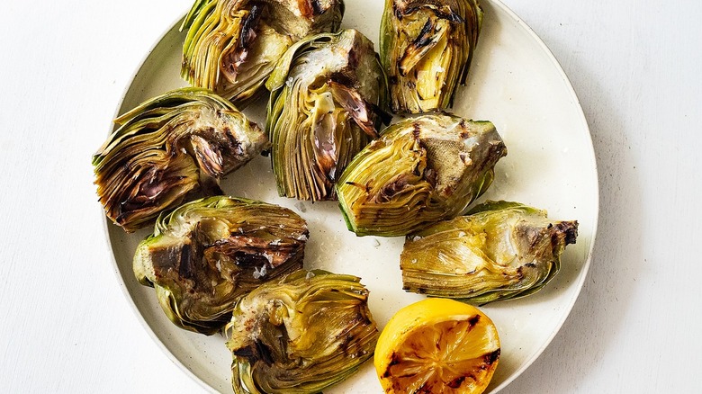 grilled artichokes and lemon on plate