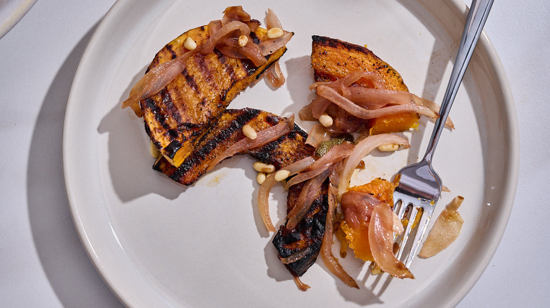 butternut squash agrodolce on a plate with a fork
