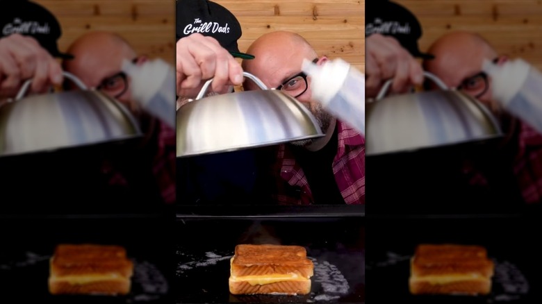 Placing metal cloche on top of grilled cheese