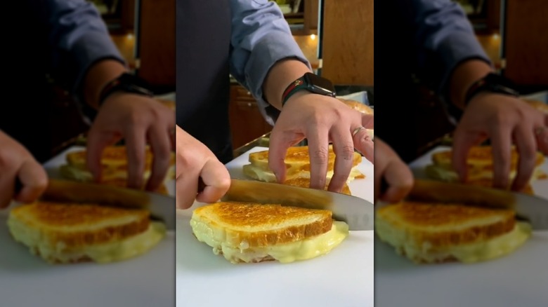 Cutting grilled cheese sandwich in half
