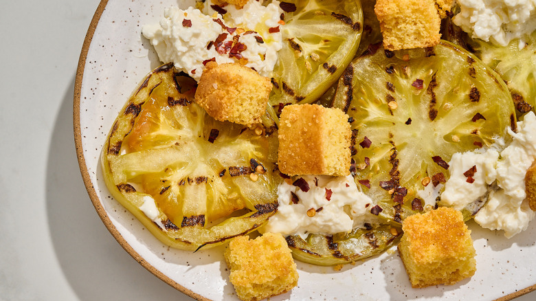 grilled green tomato salad on a platter