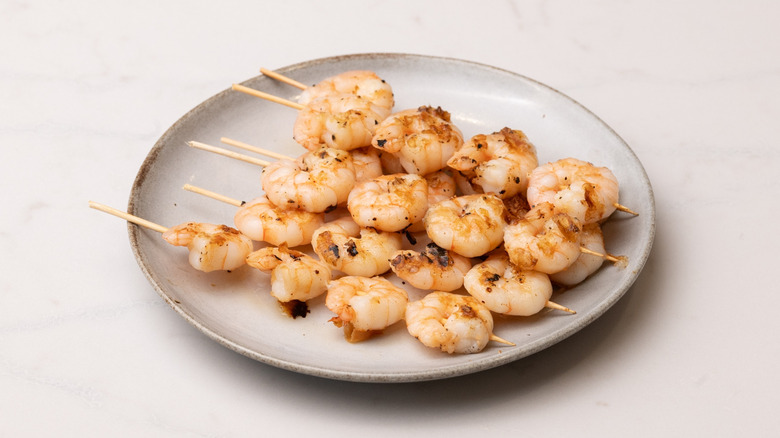 cooked shrimp skewers on plate