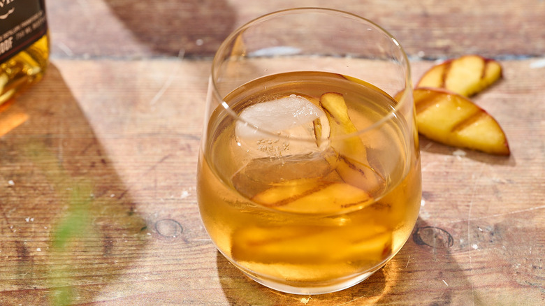 grilled peach old fashioned on a table