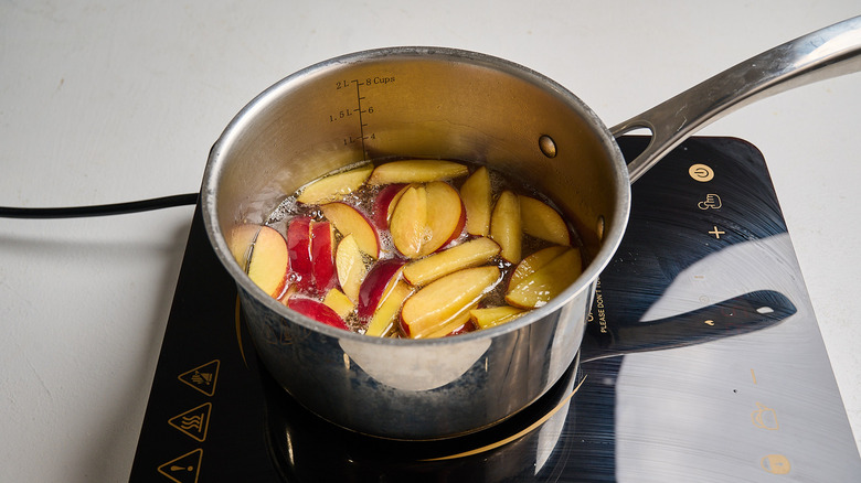 steeping peaches in sugar water in a saucepan