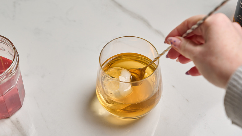 stirring cocktail in a glass