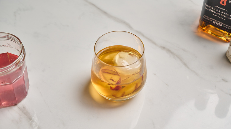 garnishing old fashioned with peaches