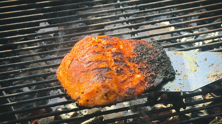 Lifting salmon off the grill with spatula