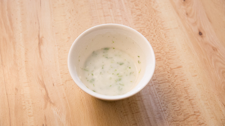 yogurt sauce in a small dish on wooden surface