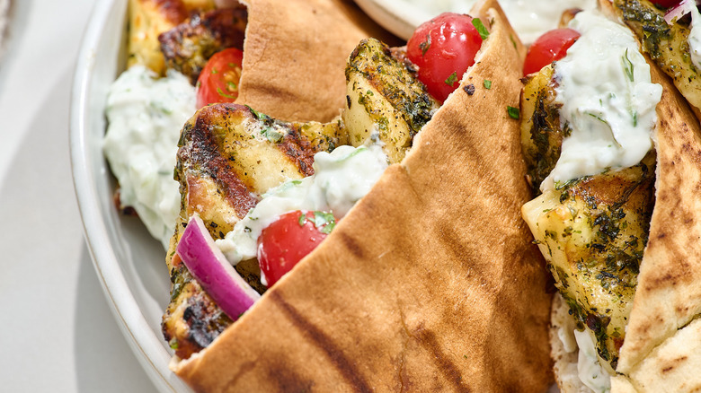 halloumi-stuffed pitas with tomato salad and tzatziki