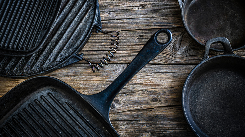 cast iron grill pans on wooden surface
