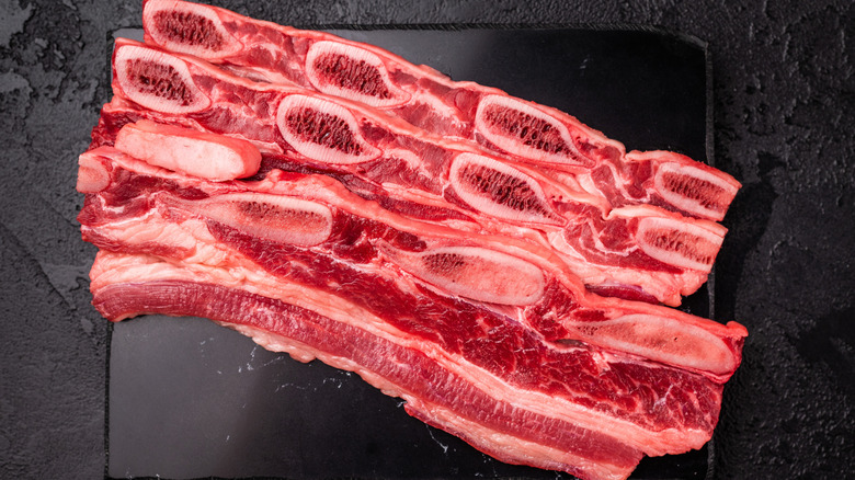 raw short rib cut into strips and laid on slab