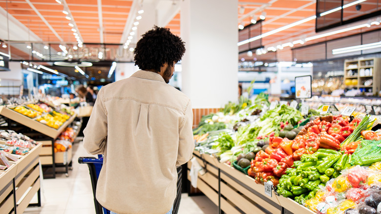 Customer shopping for fresh vegetables and fruit in a grocery store