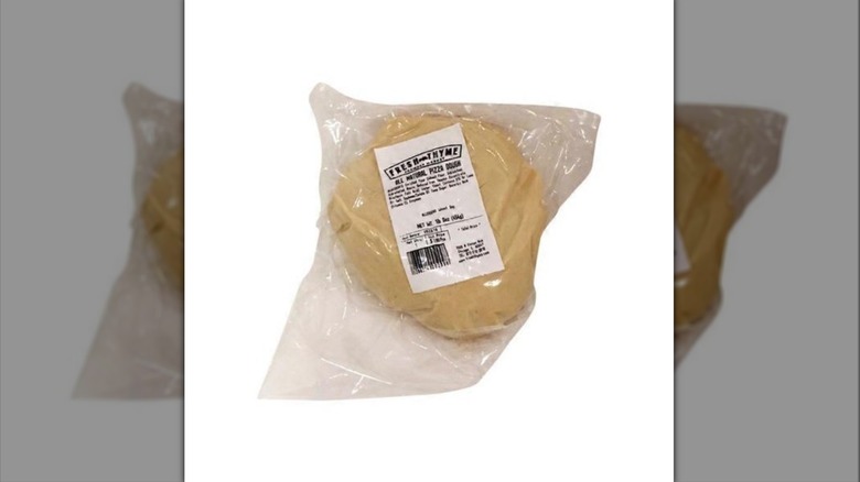Ball of Fresh Thyme Market pizza dough inside plastic package