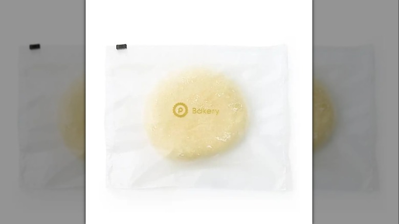 Ball of Publix store brand fresh pizza dough inside plastic package