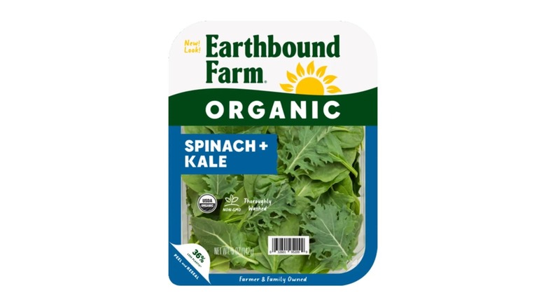 A container of Earthbound Farm Organic Chopped Spinach on a white background
