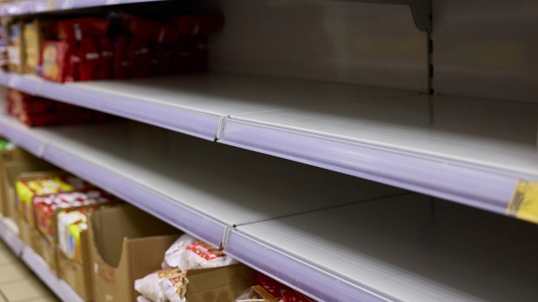 Shelves with empty section in grocery store