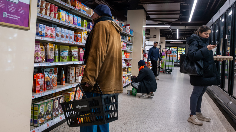 People buying and browsing groceries.