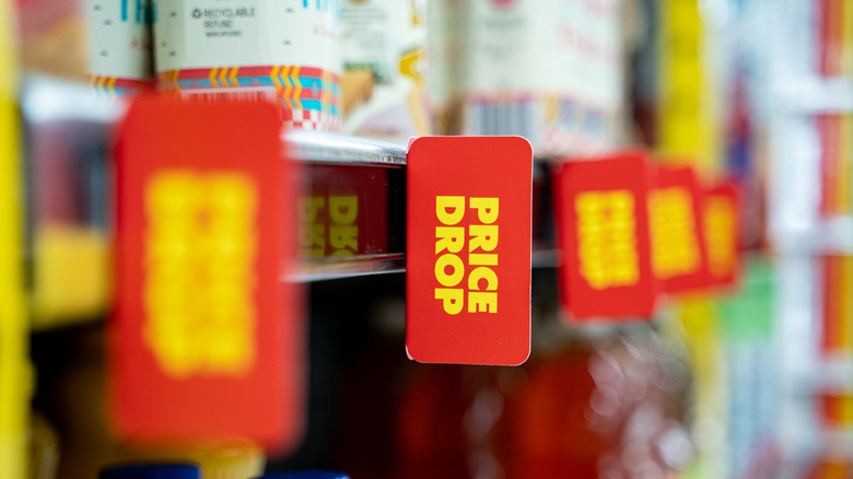 Price drop signs in supermarket.