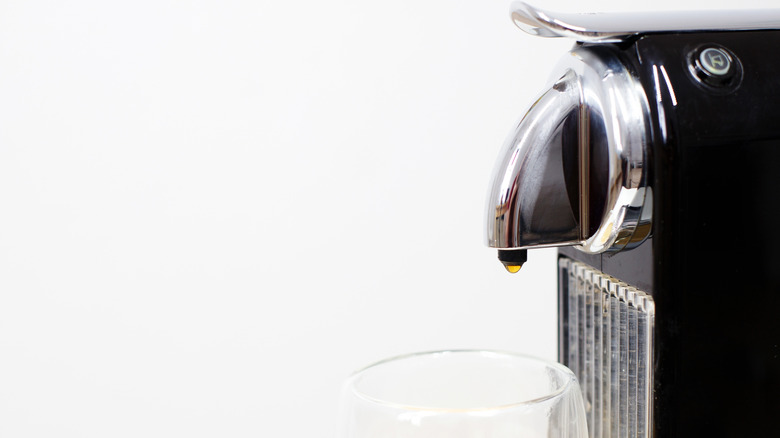 A side profile shows a black Nespresso machine.
