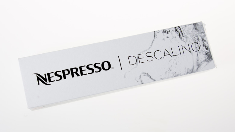 A Nespresso descaling kit box is shown.
