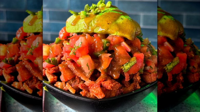 bowl of chicharrons with pico de gallo and avocado closeup, mirrored image
