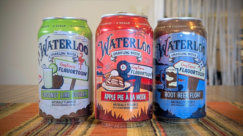 Three colorful Waterloo sparkling water cans on a table
