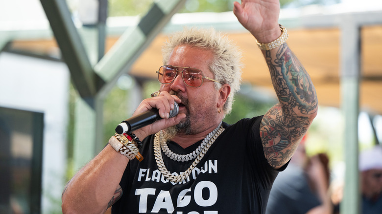 Guy Fieri talking into a microphone