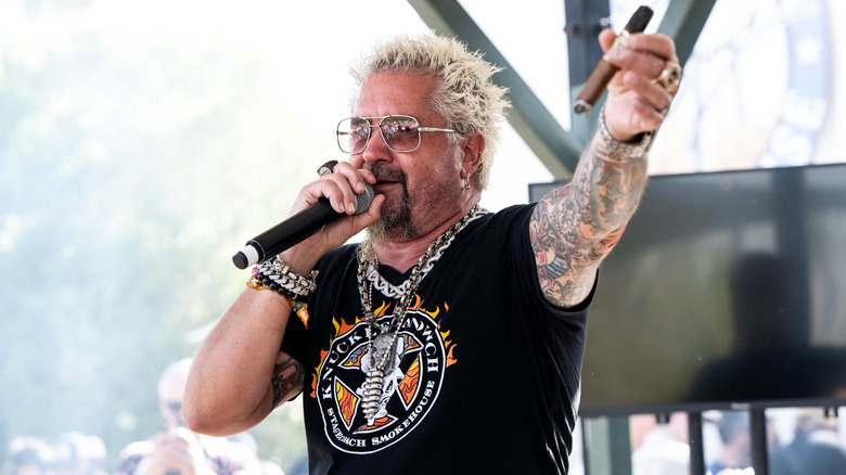 Guy Fieri holding a cigar