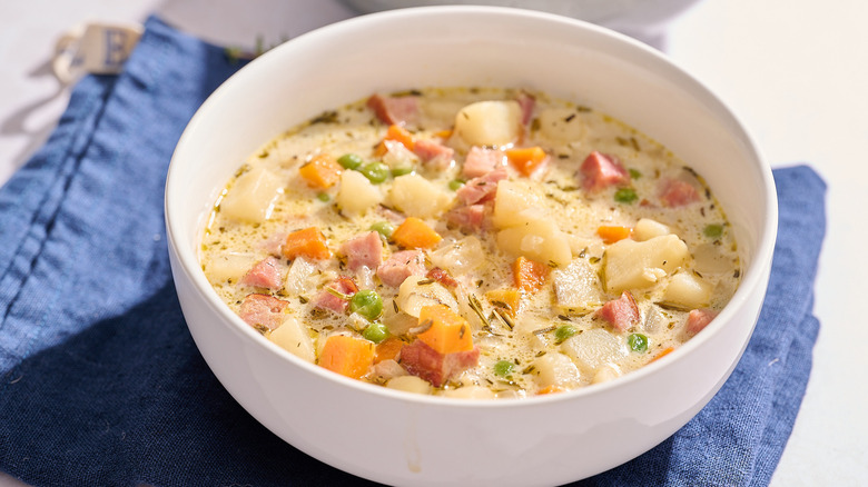 bowl of ham and potato soup on a table